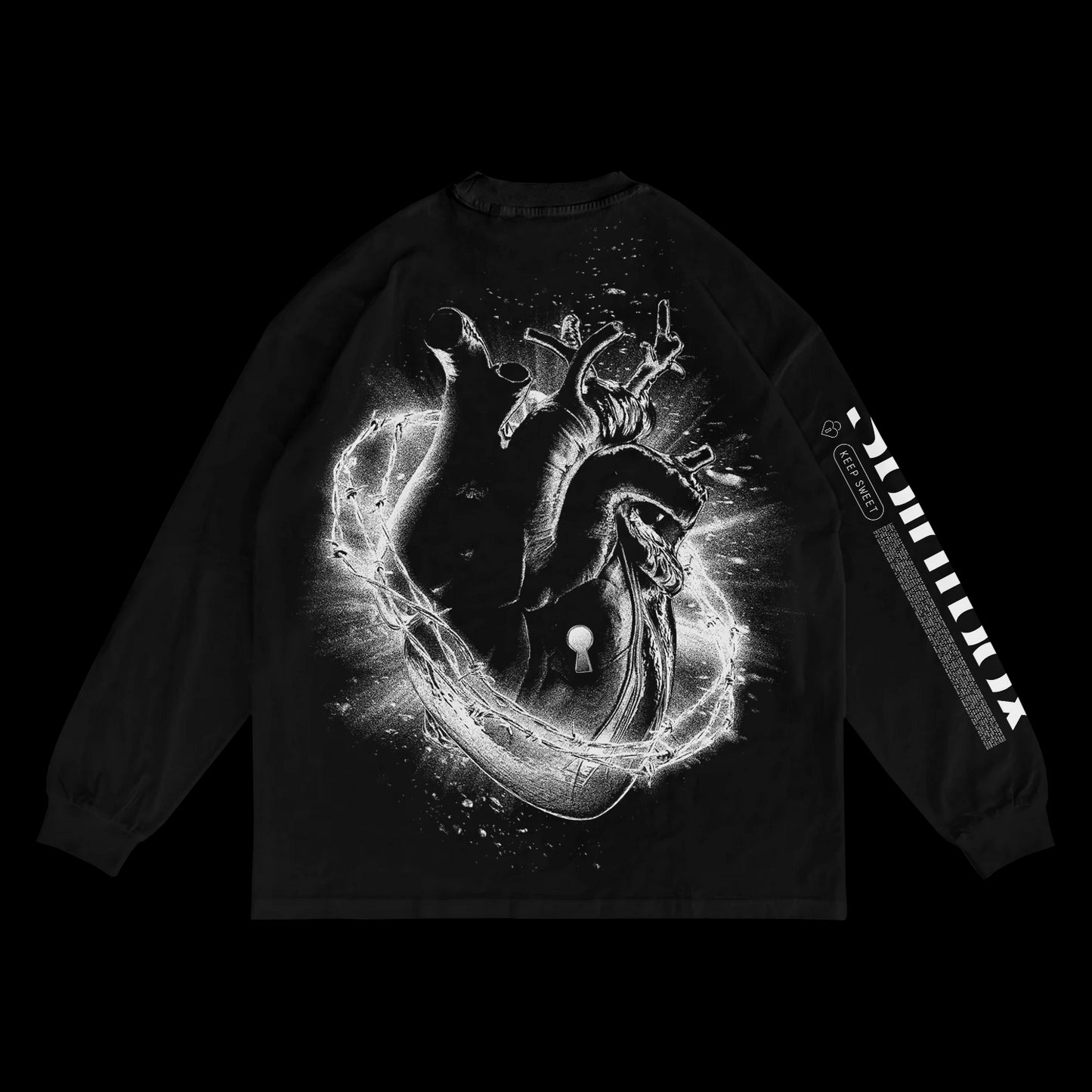 A black heavyweight long sleeve shirt by Spiritbox, garment dyed for a rich finish. Features a large anatomical heart with glowing energy on the back and bold white graphic text on the right sleeve.