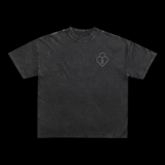 A black, short-sleeve Spiritbox T-shirt featuring a small white heart-shaped padlock graphic on the left chest, displayed on a plain black background.
