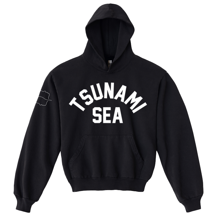 Black hooded sweatshirt by Spiritbox with TSUNAMI SEA in large white letters on the front and a small wave outline on the sleeve. Features a front pocket, ribbed cuffs, and bold printed garment style. Premium Los Angeles Apparel piece.
